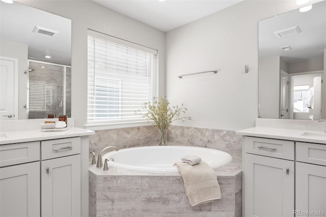 15608 E Otero Cir, Centennial, CO 80112 - bathroom featuring a shower stall, two vanities, and a bath