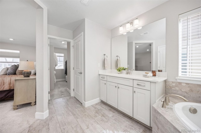 15608 E Otero Cir, Centennial, CO 80112 - ensuite bathroom with a garden tub, vanity, and baseboards