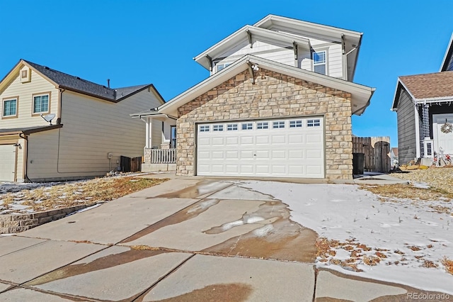 view of front property with a garage and cooling unit