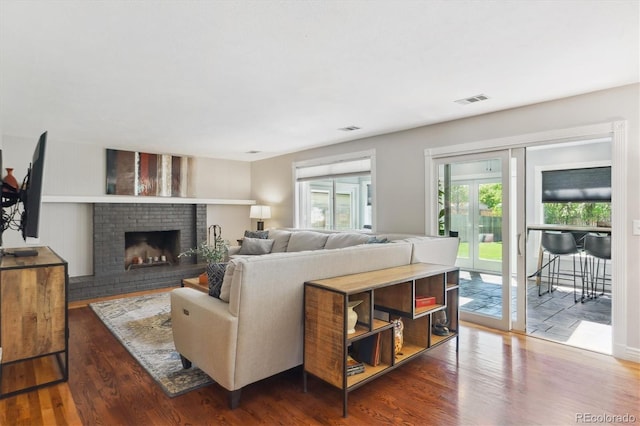6537 S Brentwood Way, Littleton, CO 80123 - living room with wood finished floors and a brick fireplace