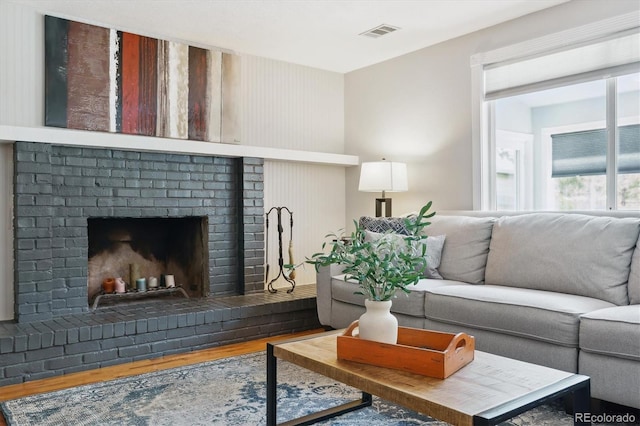 6537 S Brentwood Way, Littleton, CO 80123 - living room with a brick fireplace and wood finished floors