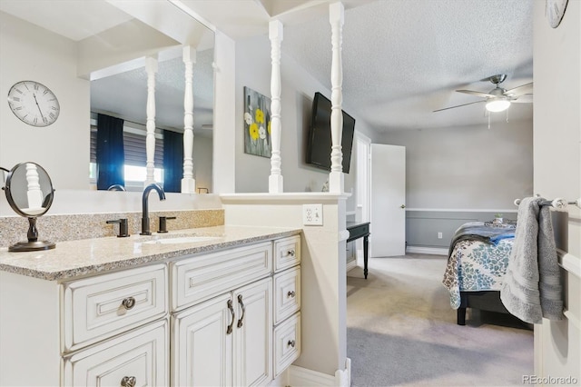 6537 S Brentwood Way, Littleton, CO 80123 - bathroom featuring a ceiling fan, vanity, and a textured ceiling