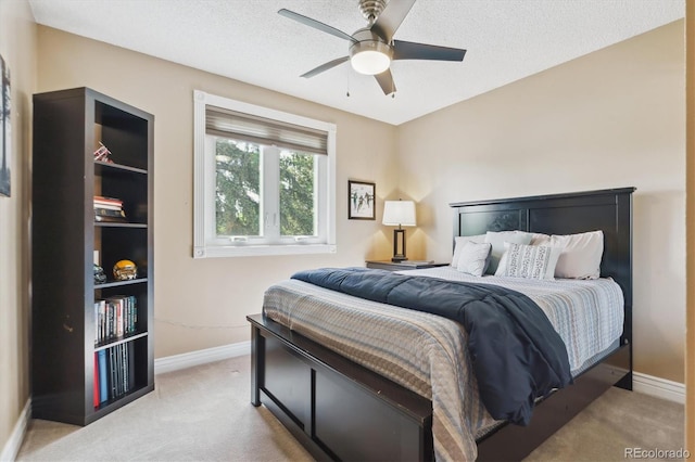 6537 S Brentwood Way, Littleton, CO 80123 - bedroom featuring light carpet, baseboards, a ceiling fan, and a textured ceiling