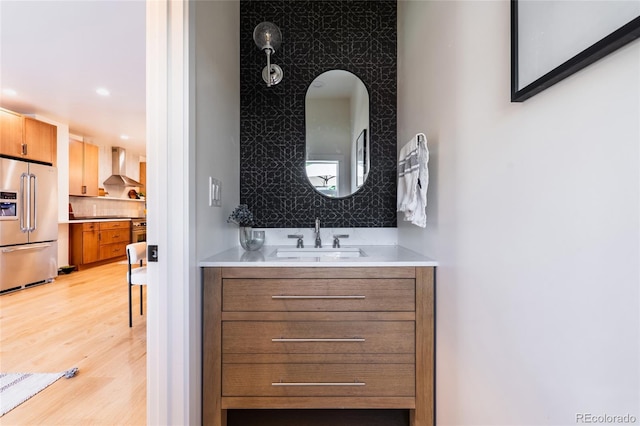 3363 W 32nd Ave, Denver, CO 80211 - bathroom featuring vanity, wood finished floors, recessed lighting, and backsplash