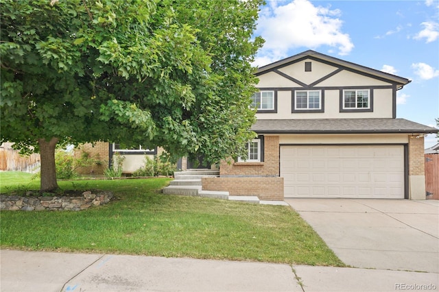 6451 S Hoyt St, Littleton, CO 80123 - view of front of property featuring a garage, driveway, brick siding, and stucco siding