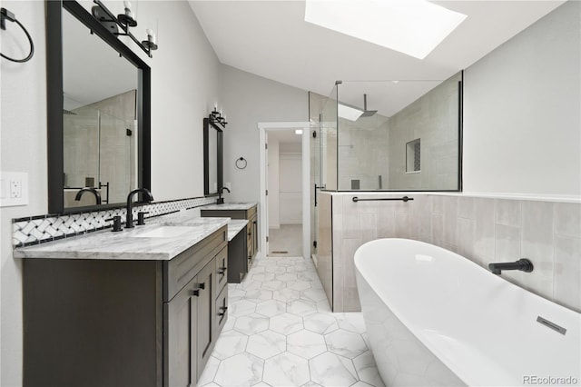 6451 S Hoyt St, Littleton, CO 80123 - bathroom featuring a shower stall, vanity, lofted ceiling, a freestanding tub, and a skylight