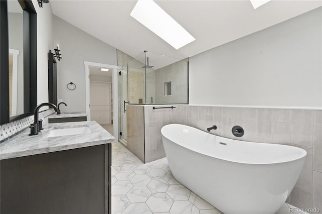 6451 S Hoyt St, Littleton, CO 80123 - bathroom with lofted ceiling, tile walls, a stall shower, a soaking tub, and double vanity