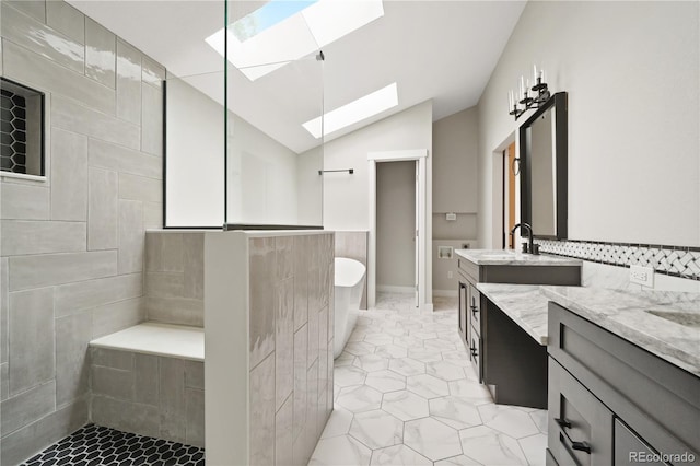 6451 S Hoyt St, Littleton, CO 80123 - bathroom with a skylight, vanity, tile patterned floors, a freestanding tub, and vaulted ceiling