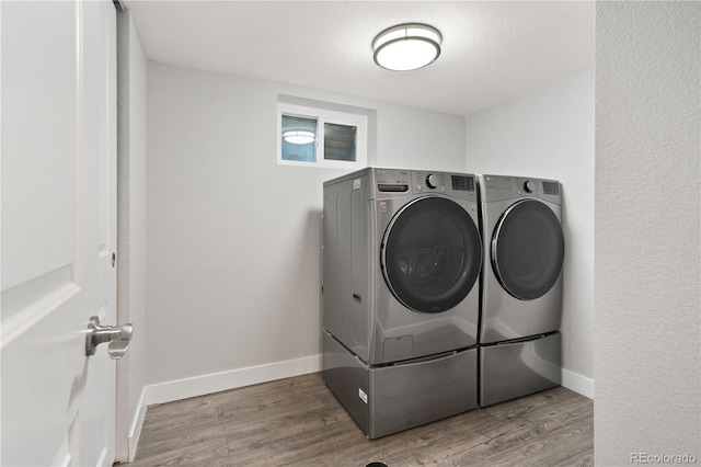 6451 S Hoyt St, Littleton, CO 80123 - laundry room with washing machine and clothes dryer and wood finished floors