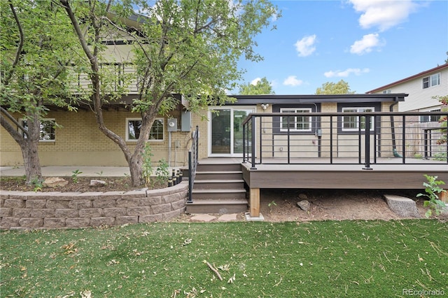6451 S Hoyt St, Littleton, CO 80123 - rear view of property featuring brick siding, a yard, and a deck