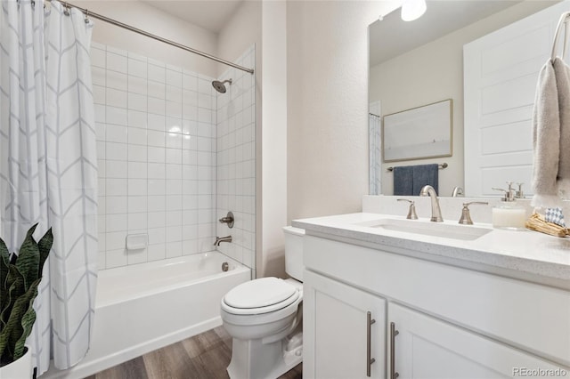 bathroom featuring vanity, shower / bath combo with shower curtain, toilet, and wood finished floors