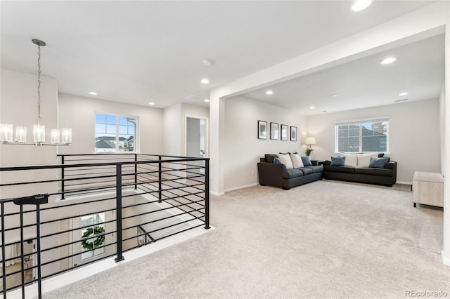carpeted living area featuring recessed lighting, a chandelier, and a wealth of natural light