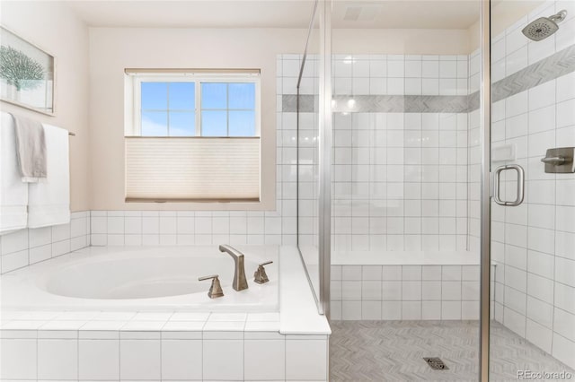 bathroom with a stall shower and a bath