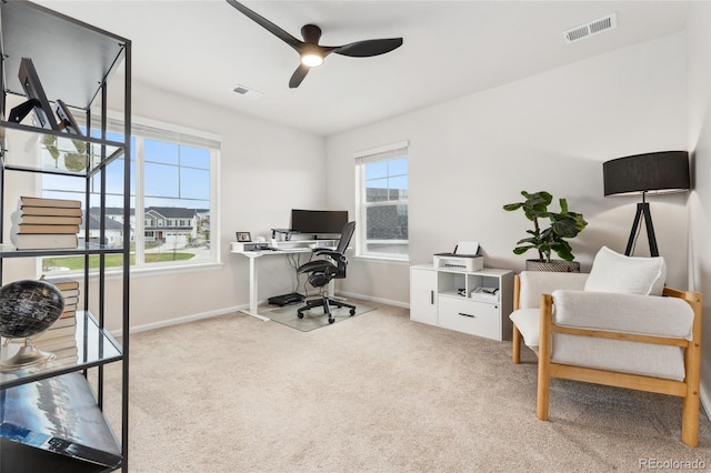 office area with carpet floors, ceiling fan, baseboards, and visible vents