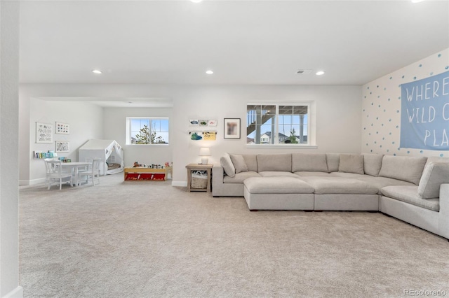 carpeted living area featuring recessed lighting, baseboards, and visible vents