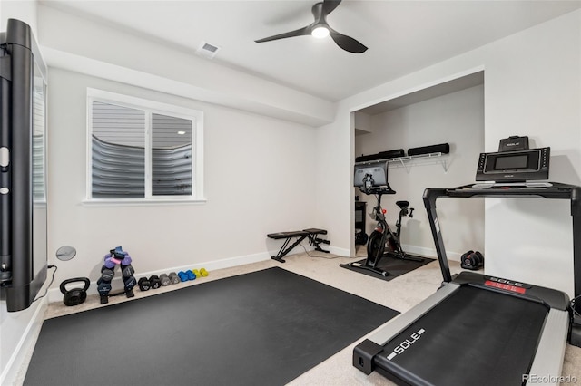 exercise area featuring carpet flooring, ceiling fan, visible vents, and baseboards