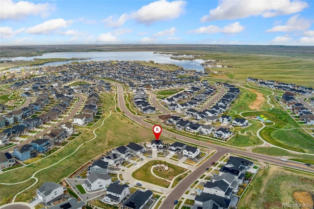 drone / aerial view featuring a water view and a residential view