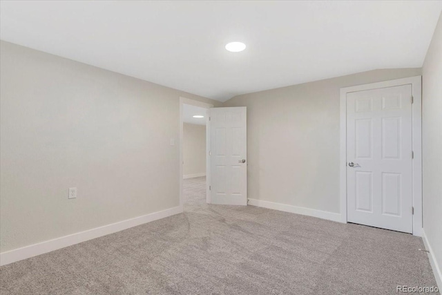 empty room with light colored carpet and baseboards