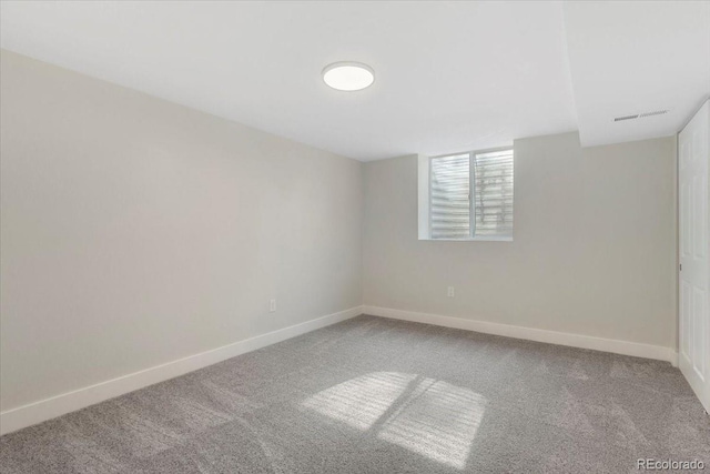 below grade area featuring baseboards, visible vents, and carpet floors