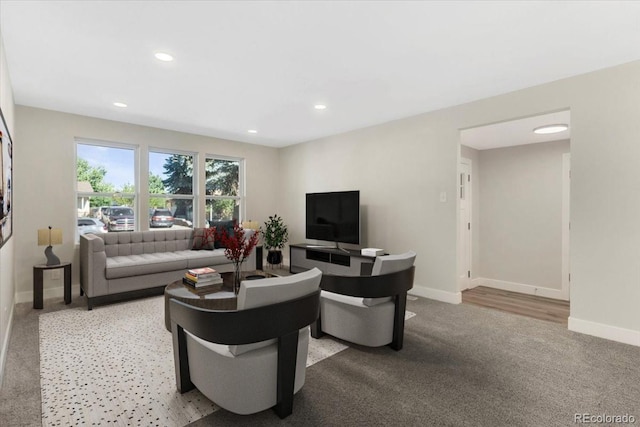 living room with recessed lighting, baseboards, and carpet flooring