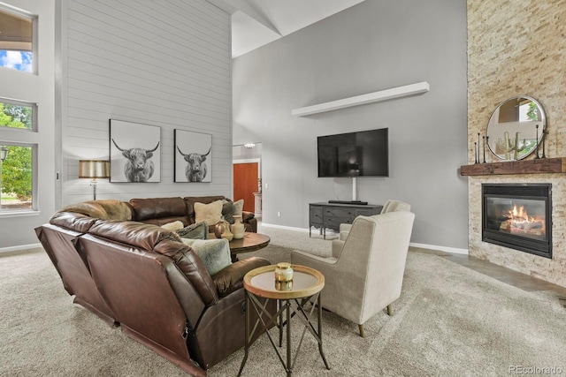 living room featuring high vaulted ceiling and light carpet