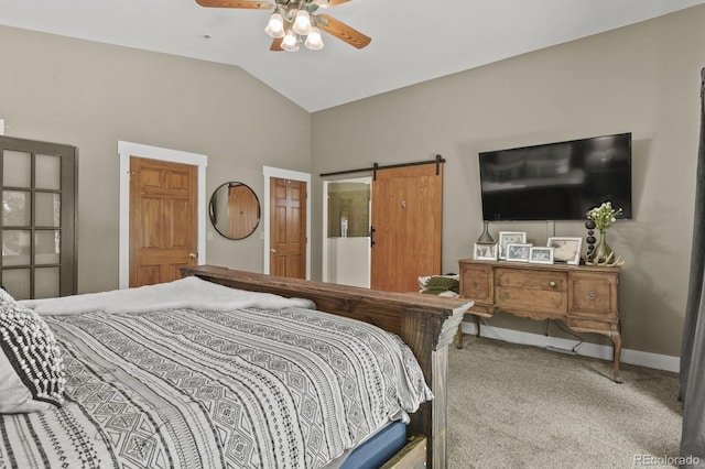 bedroom with a barn door, ceiling fan, lofted ceiling, and carpet floors