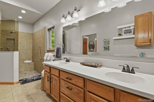 bathroom with vanity, tile patterned floors, and a tile shower