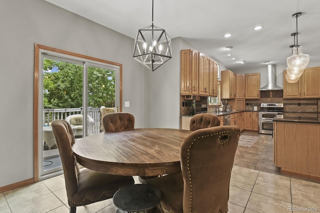 dining area with a notable chandelier, sink, and light tile patterned floors