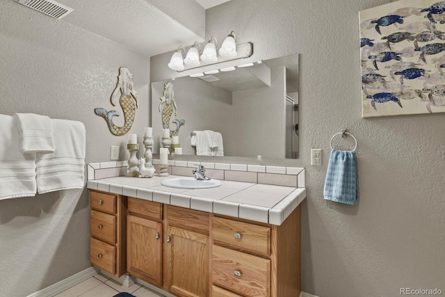 bathroom with vanity and tile patterned flooring