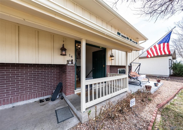entrance to property featuring brick siding and board and batten siding