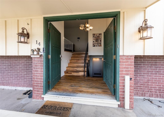 view of exterior entry with brick siding