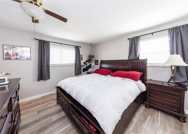 bedroom featuring light wood-style floors, baseboards, and a ceiling fan