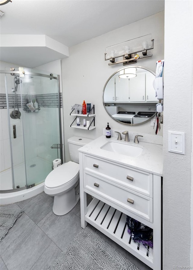 full bathroom with toilet, vanity, a stall shower, and tile patterned flooring