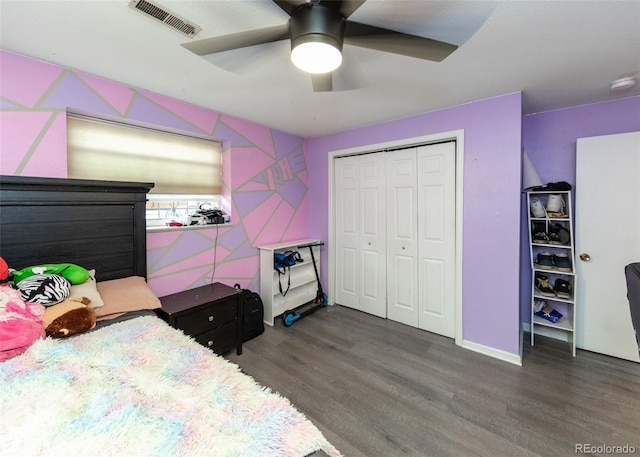 bedroom with visible vents, a closet, a ceiling fan, and wood finished floors