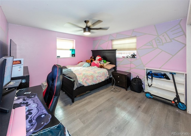 bedroom featuring wood finished floors and a ceiling fan