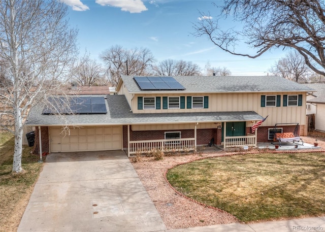 view of front of house featuring a garage, brick siding, driveway, and covered porch