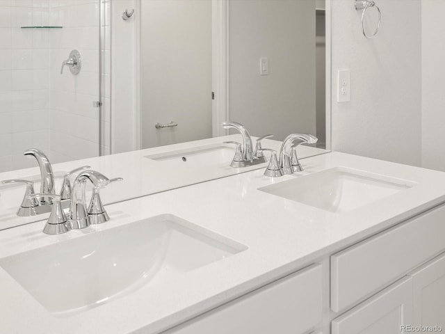 4694 Sugarcane St, Johnstown, CO 80534 - bathroom featuring double vanity and tiled shower