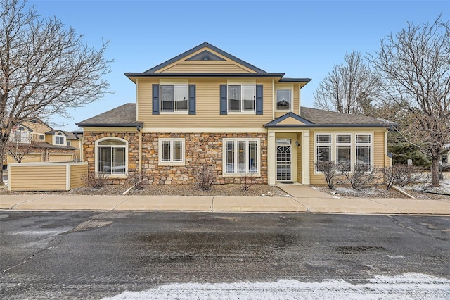 traditional-style home with stone siding