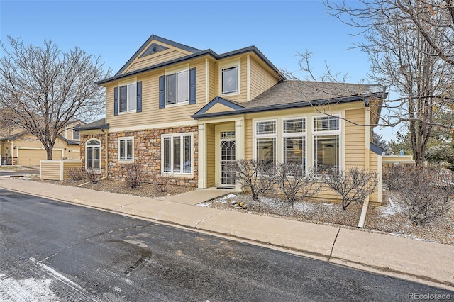 traditional-style house featuring stone siding