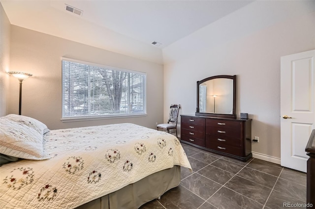 bedroom featuring dark tile patterned floors, visible vents, and baseboards