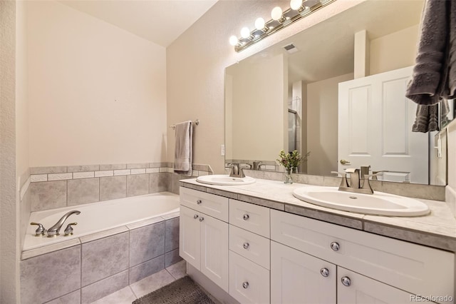 full bathroom with double vanity, tile patterned flooring, a sink, and visible vents