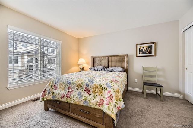 bedroom featuring carpet flooring, visible vents, and baseboards