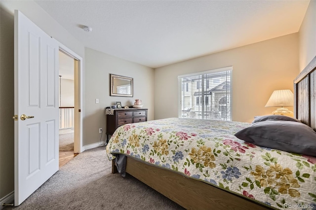 carpeted bedroom featuring baseboards