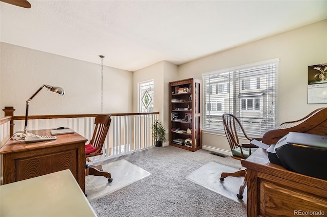 office featuring light carpet, visible vents, and baseboards