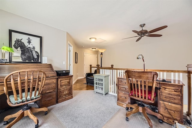 home office with ceiling fan, baseboards, and carpet flooring