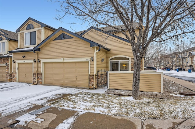 view of front facade featuring a garage and stone siding