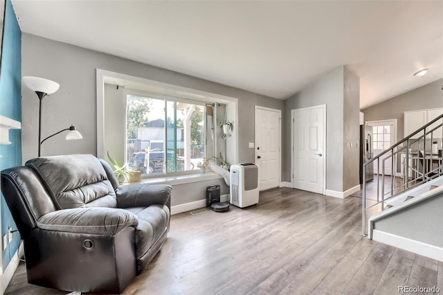 living room with lofted ceiling and wood-type flooring