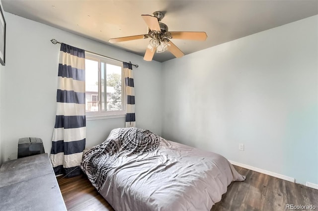 bedroom with ceiling fan and dark hardwood / wood-style flooring