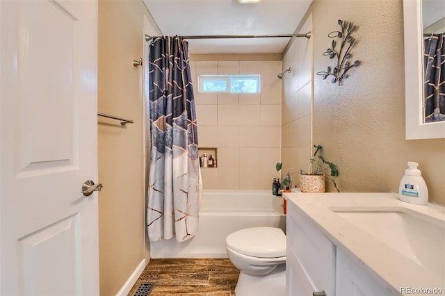 full bathroom with hardwood / wood-style flooring, vanity, shower / tub combo, and toilet