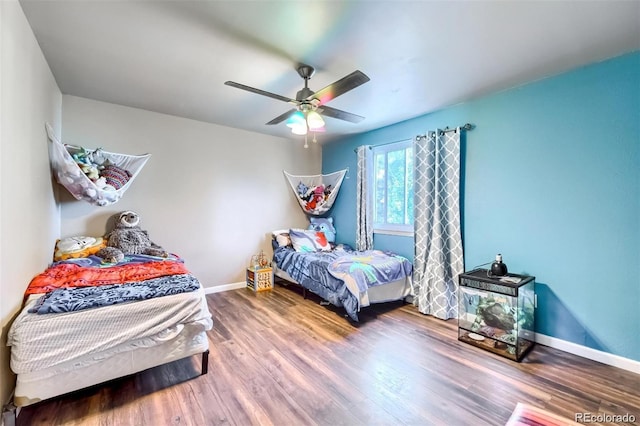 bedroom featuring wood-type flooring and ceiling fan